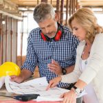 Builder and Homeowner discussing construction plans at home site