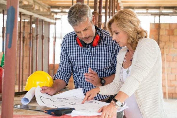 Builder and Homeowner discussing construction plans at home site